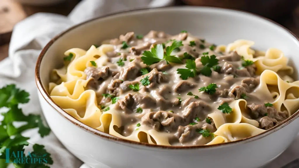 Cream of mushroom soup and beef broth poured into a skillet.