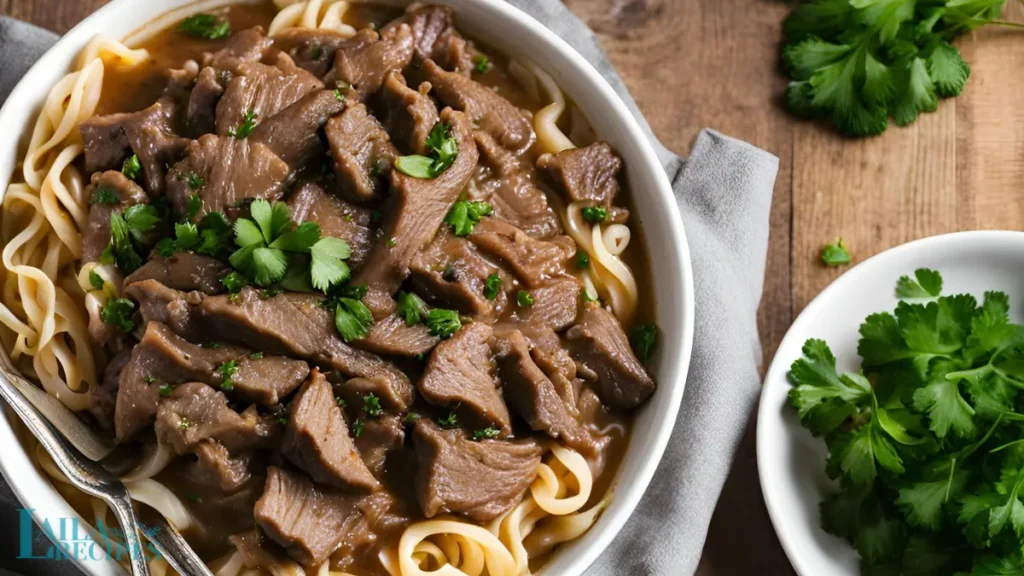 Close-up of beef and noodles in a bowl.