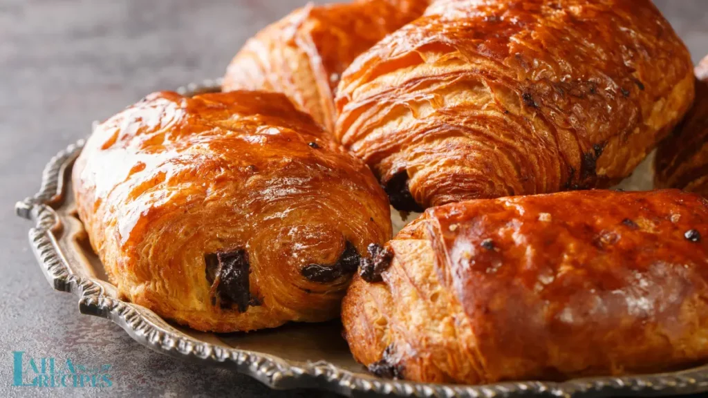 Chocolate croissants served with a cup of coffee.