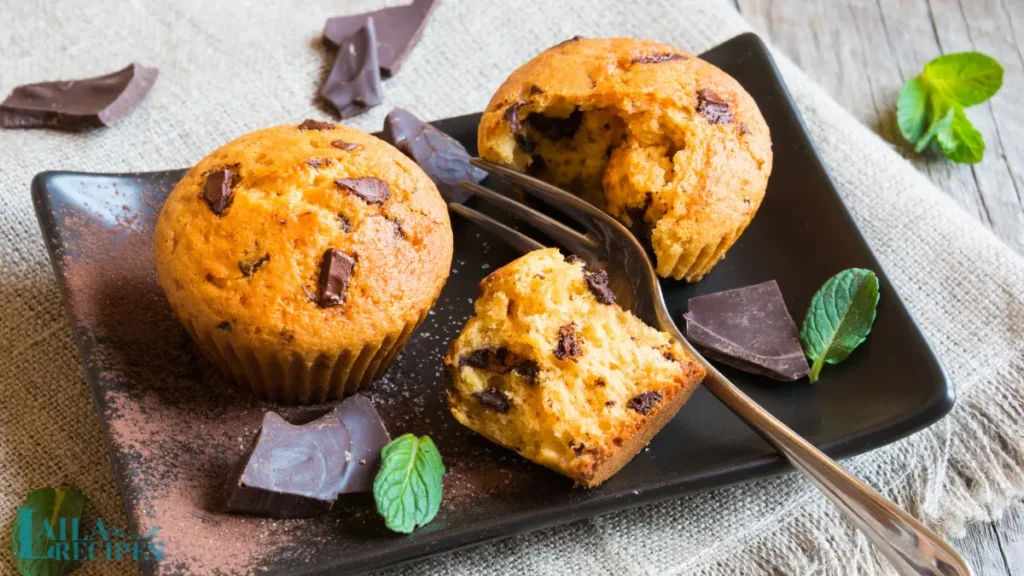 Close-up of a muffin batter being scooped into a muffin tray.