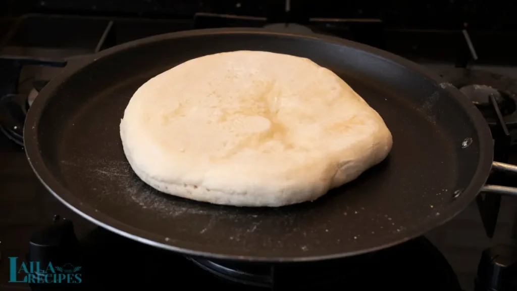 Homemade soft and fluffy Turkish Pide bread on a wooden board.