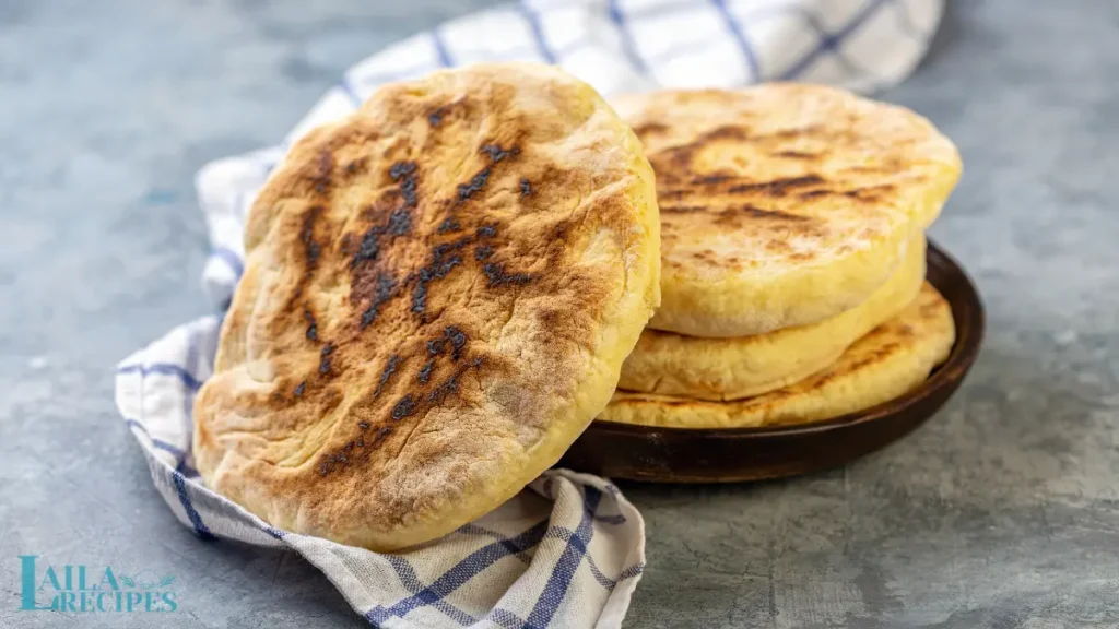 Soft, golden flatbread with sesame seeds on top.